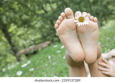 Child feet on green grass, barefoot little girl on meadow, countryside lifestyle, concept of grounding and connecting with nature - Shutterstock ID 2359137289