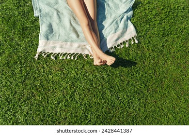  Child feet on green grass, barefoot little girl on meadow. Sunbathing on the green grass - lifestyle, concept of grounding and connecting with nature. - Powered by Shutterstock