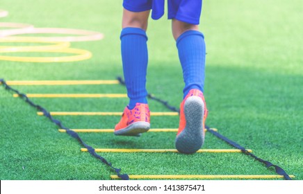 Child Feet With Soccer Boots Training On Agility Speed Agility Ladder For Football Sport Training Skill In Soccer Academy School. For Kid Sport Training Concept.