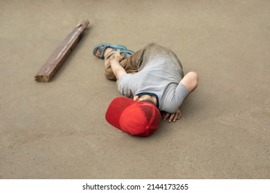 The Child Fell To The Asphalt. Dangerous Fall Of The Child. The Boy Lies And Does Not Move. The Son Stumbled. Bad Student Behavior.