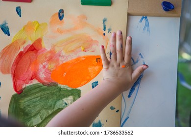 Child Finger Painting On Manila Paper