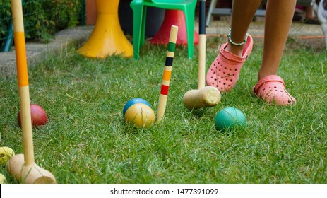 Child finishing a game of backyard croquet