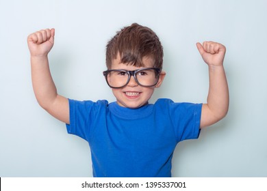 Child Flexing Muscles Isolated. Super Strong Kid. Child Pretend To Be Superhero. Success, Win And Imagination Concept