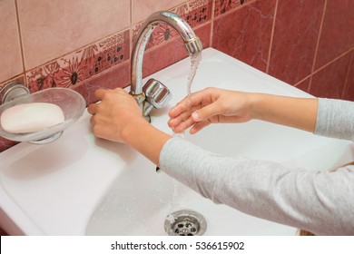 Child Framed Hand Under The Stream Of Cold Water