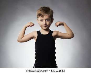 Child. Funny Little Boy.Sport Handsome Boy. Strong. bodybuilder. showing his hand biceps muscles