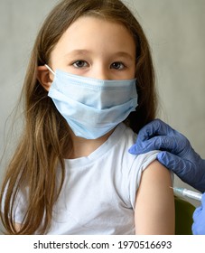 Child Getting Vaccine Injection, Portrait Of Adorable Kid Looking At Camera And Jab. Eyes Of Pretty Girl In Face Mask From Corona Or Monkeypox Virus. Concept Of School, Shot And COVID-19 Vaccination.