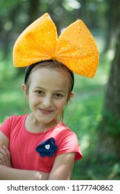 Child With A Giant Bow On His Head