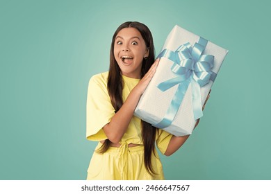 Child with gift present box on isolated studio background. Gifting for kids birthday. Surprised face, surprise emotions of teenager girl. - Powered by Shutterstock