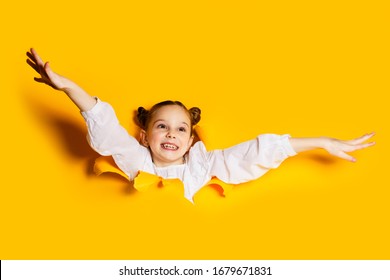 Child Girl Breaks Through A Paper Wall