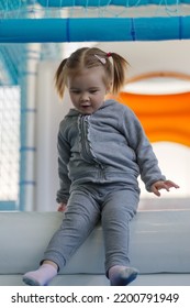 Child Girl Climbing Down Ramp In Soft Play Centre