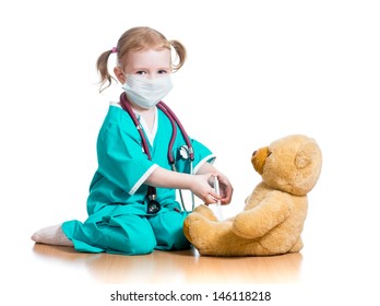 Child Girl With Clothes Of Doctor Playing Toy