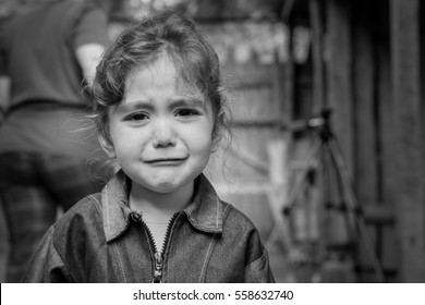 The Child - A Girl Crying. In The Eyes Visible Tears.