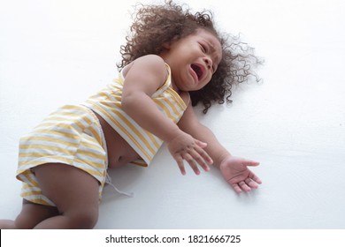  Child Girl Crying And Shouting With Tantrum Lying On The Floor At Home