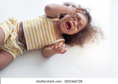  Child Girl Crying And Shouting With Tantrum Lying On The Floor At Home