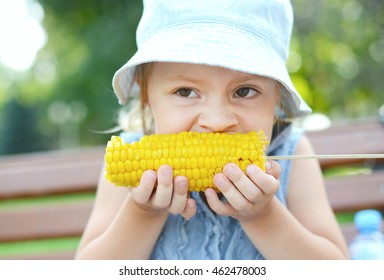 Child Girl Eating Corn On The Cob