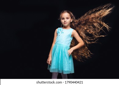 Child Girl With Extra Long And Volume Flying Hair. Fasion Model. Black Background. Blue Dress