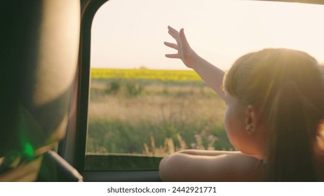 child girl face looks smiling from car out window, little girl sitting car, tourism, beautiful girl sitting back seat with her hand out window catching car sparkles, kid smiling window, child pulls - Powered by Shutterstock