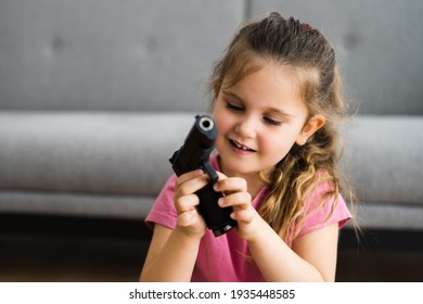 Child Girl With Gun. Kid And Children Safety