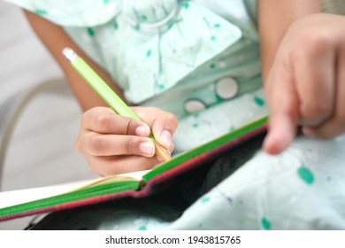 Child Girl Hand Writing On Notepad.