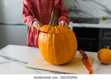 Child girl having fun at home and  preparing for Halloween, Thanksgiving. Cooking festive fare in the kitchen.	 - Shutterstock ID 2021952962