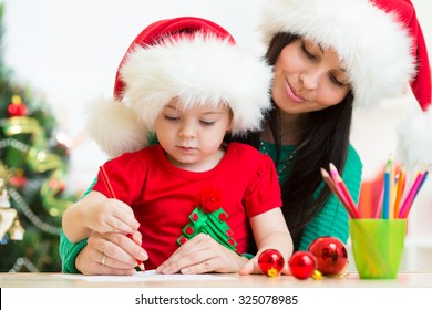 Child Girl And Her Mother Writing Letter To Santa