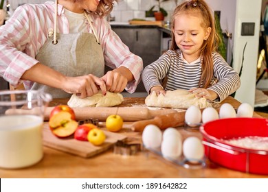 Child Girl Knead With Mom In The Kitchen, Going To Bake Delicious Cookies. Family At Home At Weekend, Mother Teach Child Girl To Cook