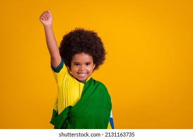 child girl latin american cheering for brazil at world cup 2022 patriot nationalist waving brazil flag cheering and jumping, symbol of happiness, joy and celebration, with flag of brazil