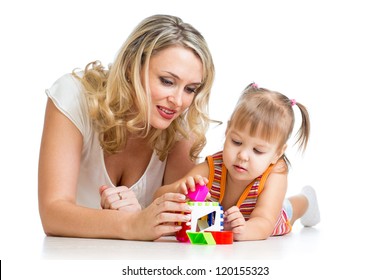 child girl and mother playing together with puzzle toy
