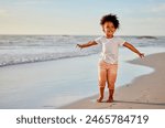 Child, girl and open arms on beach for freedom, relax and happiness on summer holiday or vacation. Smile, female perosn and travel adventure to sea for ocean waves, peace and celebration for weekend