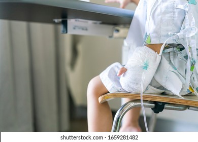 Child Or Girl Patient Sit On Chair And Hand Still Lock With Equipment Medical For Injection For Saline Or Vitamin Or Infusion Intravenous