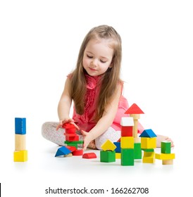 child girl playing with colorful building block toys