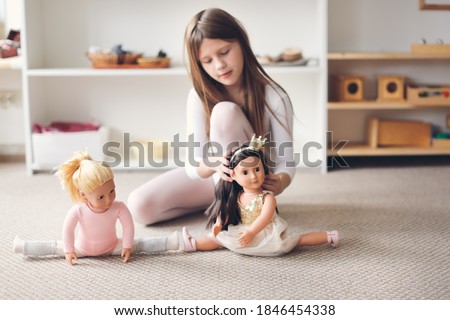 A child girl plays with dolls, a girl in a dance costume is engaged in gymnastics and ballet with a doll, role-playing and story games, sports and stretching, gentle colors