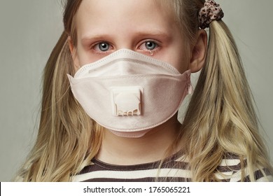 Child girl in protective medical mask crying, closeup portrait