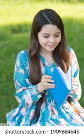 Child Girl Relaxing Outdoors With Book, New Chapter Concept.