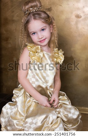 Child girl smiling gold dress