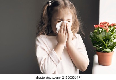 Child girl sneezing,caucasian kid blowing napkin,allergic concept. Flower,plants allergy. - Powered by Shutterstock