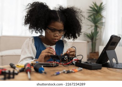 Child girl student learning and checking electric current on toy robotics at home. Technology and scientist at school concept - Powered by Shutterstock