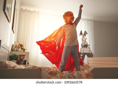 child girl in a super hero costume with mask and red cloak  at home
 - Powered by Shutterstock