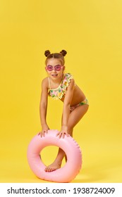 Child Girl In Swimwear With Inflatable Rubber Ring