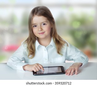 Child Girl Tablet Ipad On Table On Nature Background. Computer Technology Education Concept.Childhood Lifestyle.