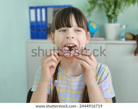 Child girl is tamed by children with a sweet tooth. Adolescent children's addiction to sweets and sugar