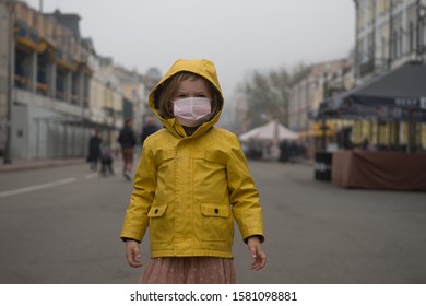 Child Girl Walking Outdoors With Face Mask Protection. Kindergarten Kid Breathing Through Medical Mask Because Of Smog And Air Pollution.