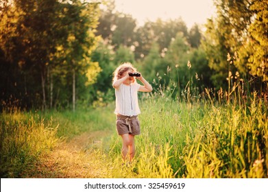 Child Girl Watching Birds With Binocular On The Walk In Sunny Summer Forest