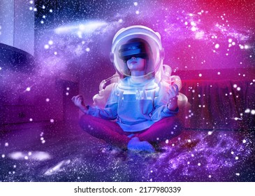 Child girl wearing virtual reality headset like as astronaut and looking at digital space system. Space exploration with augmented reality glasses. Kid is sitting on flor at childroom. - Shutterstock ID 2177980339