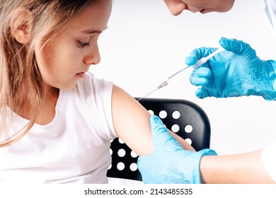 The Child Was Given A Vaccine.Female Doctor Or Nurse Trying To Give Shot Or Vaccine Against Virus To A Scared Patient. Angry And Distrustful Patient Refuses To Receive It.