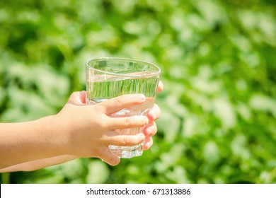 The Child Gives A Glass Of Water.