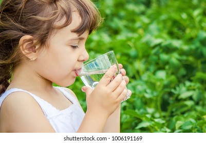 Child Glass Of Water. Selective Focus.