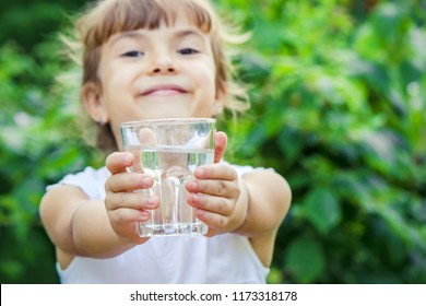 Child Glass Of Water. Selective Focus. Children