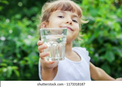 Child Glass Of Water. Selective Focus. Children