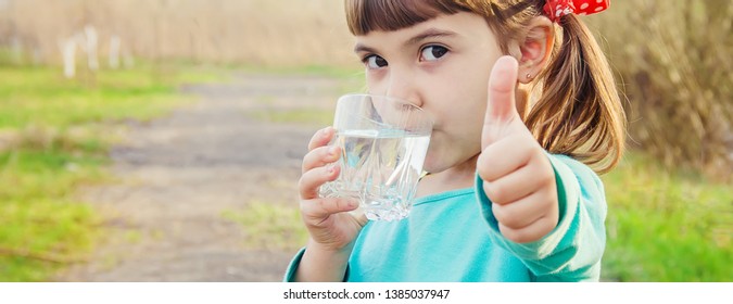 Child Glass Of Water. Selective Focus. Kids. Nature.